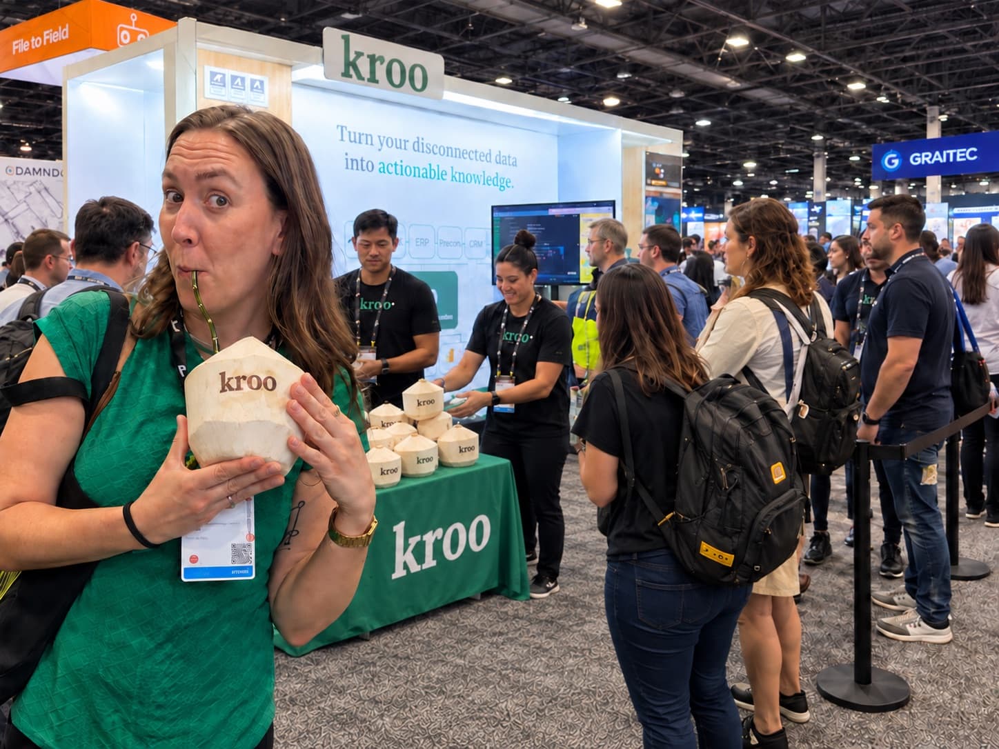 An attendee sipping from a coconut branded with a company logo